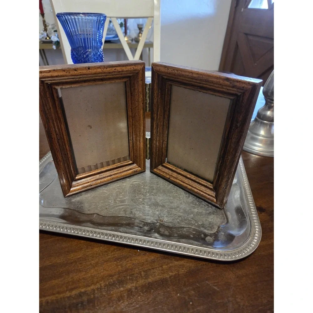 vintage bifold photo frame features a dark brown wood-grain finish and brass...